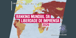 Mapa-múndi colorido em tons de amarelo, laranja e vermelho escuro, representando diferentes níveis de liberdade de imprensa. No centro, um retângulo magenta com o texto 'RANKING MUNDIAL DA LIBERDADE DE IMPRENSA 2026'. No topo esquerdo, o selo 'INFORMAÇÃO EM RISCO' e, no inferior direito, o logotipo do portal Reconhecida com o @ReconhecidaBR.